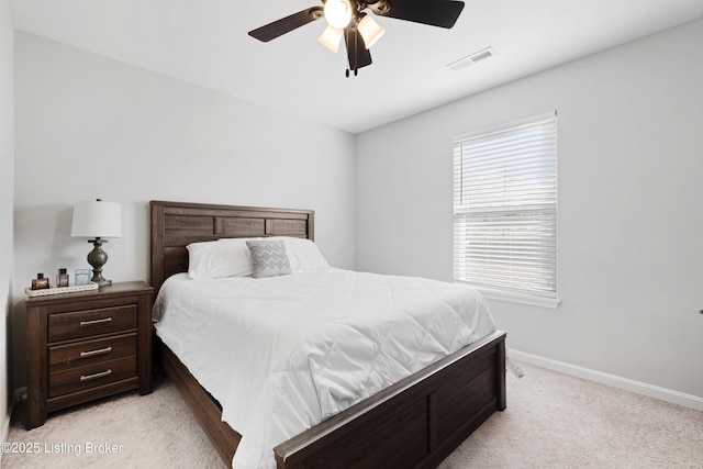 bedroom with baseboards, visible vents, ceiling fan, and light colored carpet