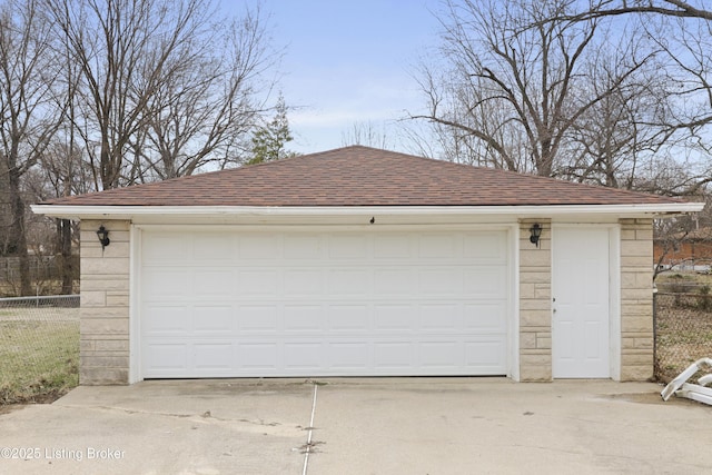 detached garage featuring fence