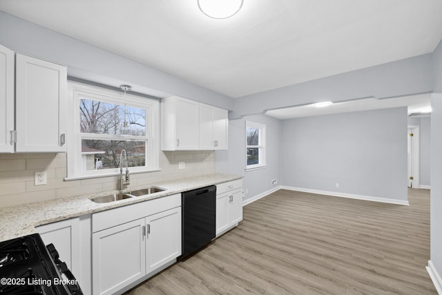 kitchen with black appliances, decorative backsplash, white cabinets, and a sink