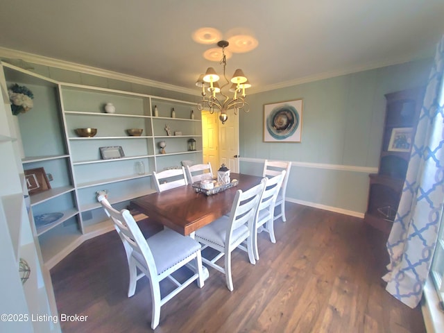 dining area with a chandelier, ornamental molding, wood finished floors, and baseboards