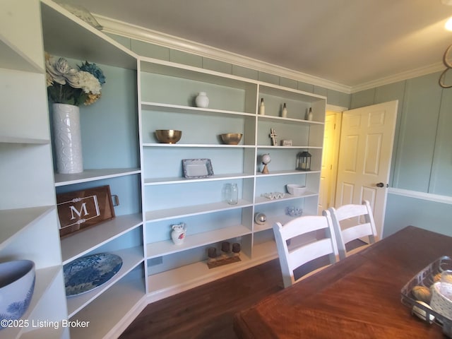 dining area featuring crown molding and wood finished floors