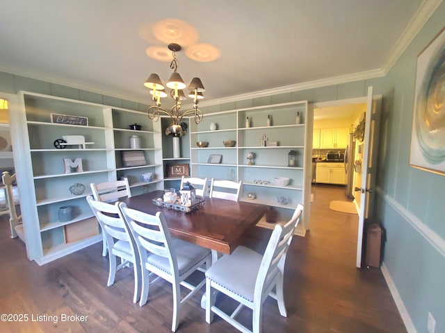 dining area featuring a notable chandelier, baseboards, dark wood finished floors, and crown molding