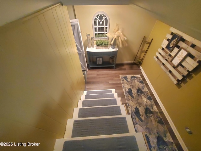 staircase featuring wood finished floors