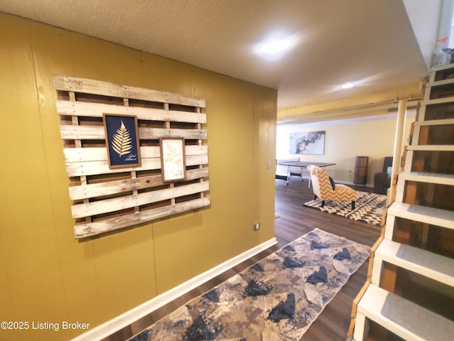 hall with wood finished floors and baseboards