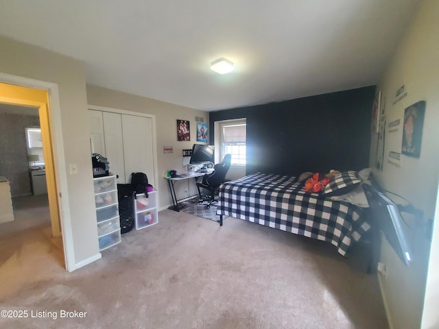 carpeted bedroom featuring a closet and baseboards