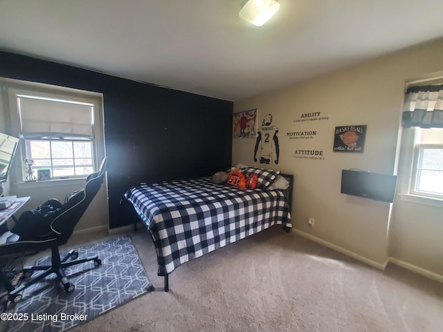 bedroom with carpet, multiple windows, and baseboards