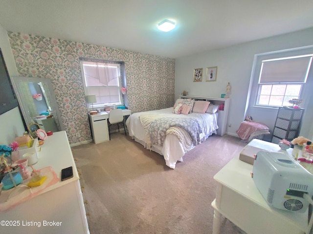 bedroom with wallpapered walls, baseboards, and light colored carpet