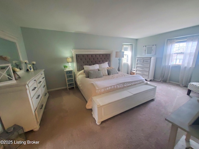 carpeted bedroom featuring baseboards