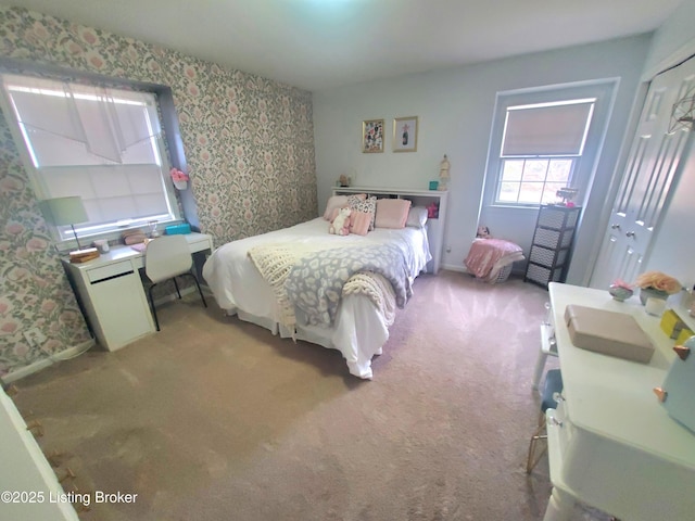 bedroom featuring carpet floors, wallpapered walls, and baseboards