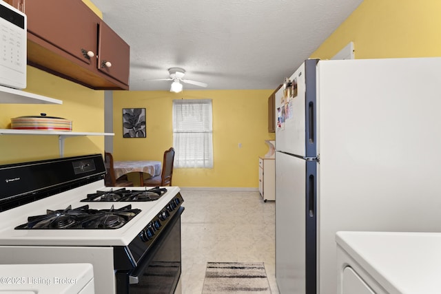 kitchen with white appliances, baseboards, ceiling fan, light countertops, and a textured ceiling