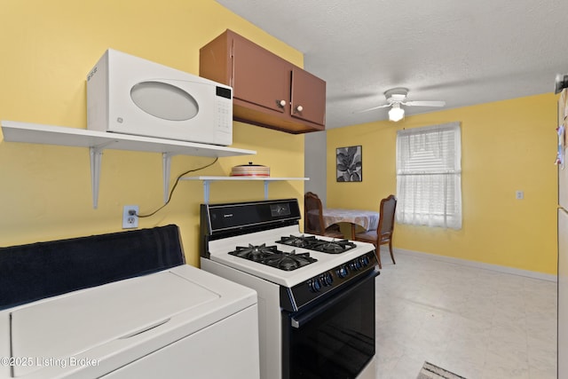 kitchen with a textured ceiling, ceiling fan, white microwave, light countertops, and range with gas cooktop