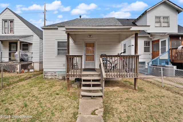 bungalow featuring a shingled roof, a front yard, and fence