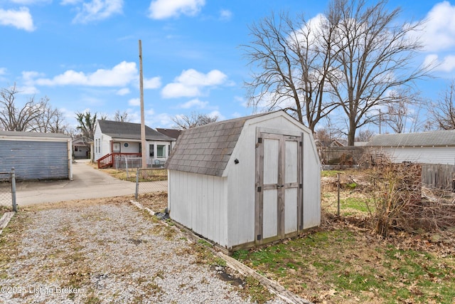 view of shed featuring fence