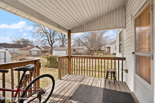 deck featuring an outdoor structure and a residential view