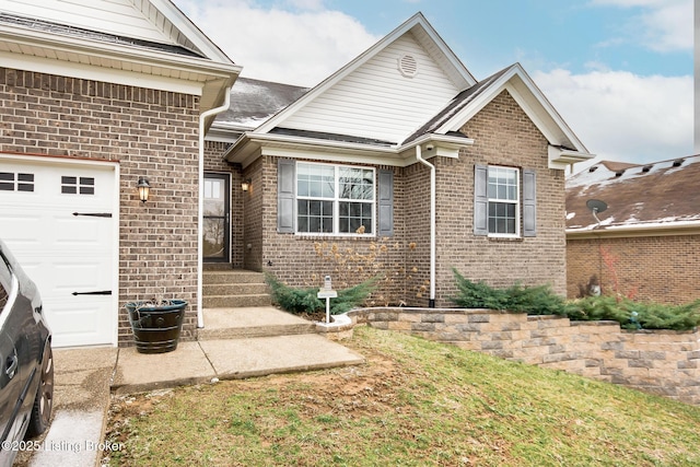 view of front of home featuring brick siding and an attached garage