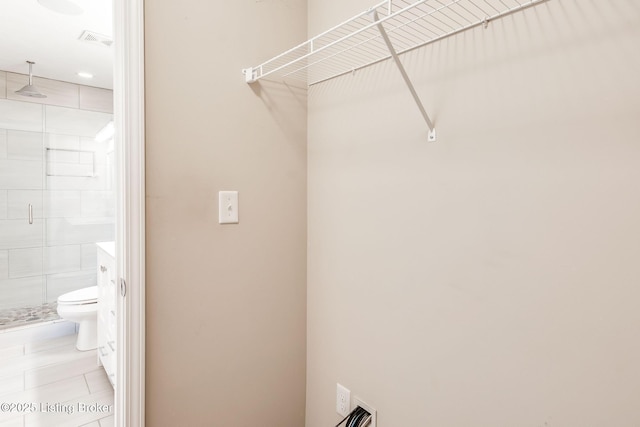 clothes washing area featuring laundry area, visible vents, and tile patterned floors