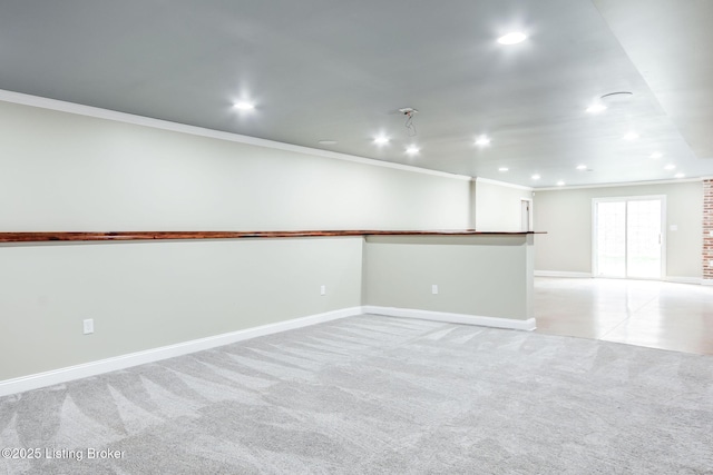 empty room with ornamental molding, recessed lighting, light carpet, and baseboards