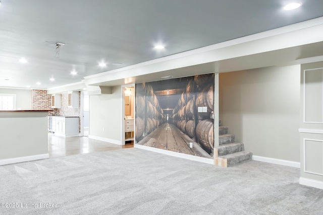 finished below grade area with recessed lighting, light colored carpet, crown molding, and stairs