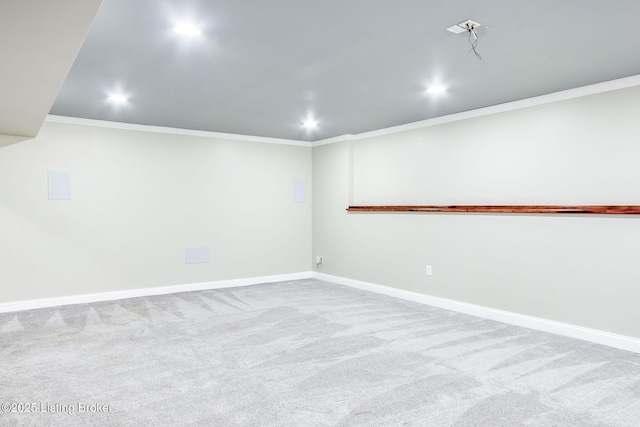 carpeted empty room featuring baseboards and ornamental molding