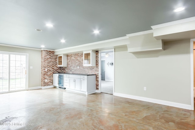 kitchen with concrete flooring, wine cooler, recessed lighting, and baseboards