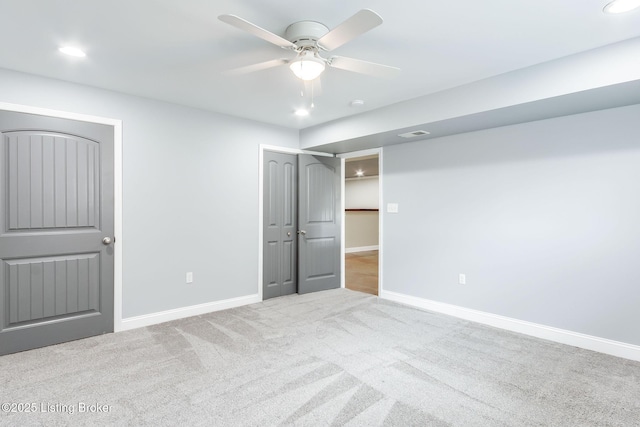 unfurnished bedroom featuring ceiling fan, carpet, visible vents, and baseboards