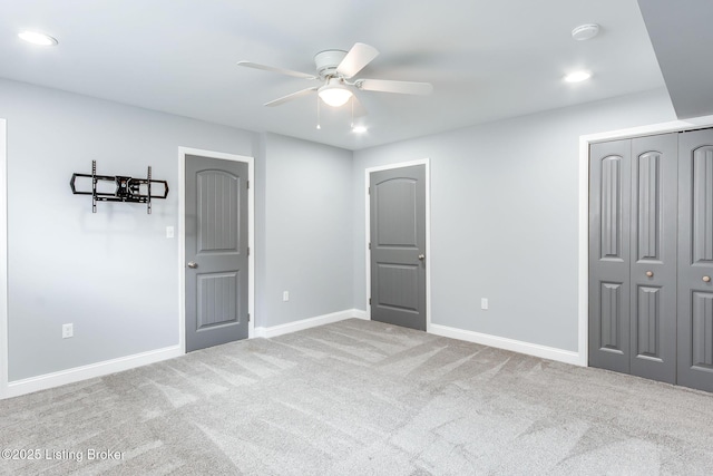 unfurnished bedroom featuring carpet floors, a closet, recessed lighting, and baseboards