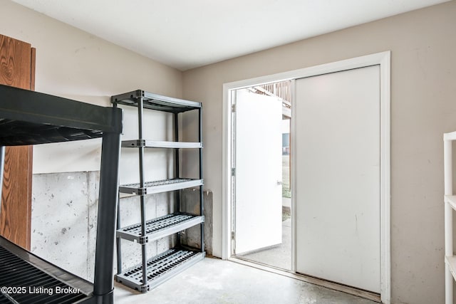 unfurnished bedroom featuring unfinished concrete floors