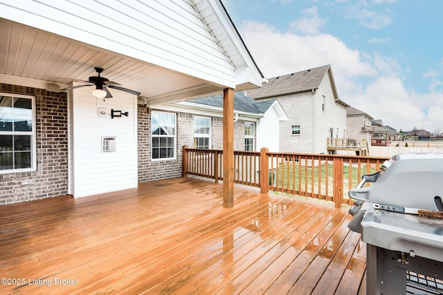 wooden terrace featuring ceiling fan and area for grilling