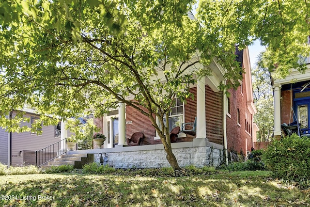 obstructed view of property with brick siding