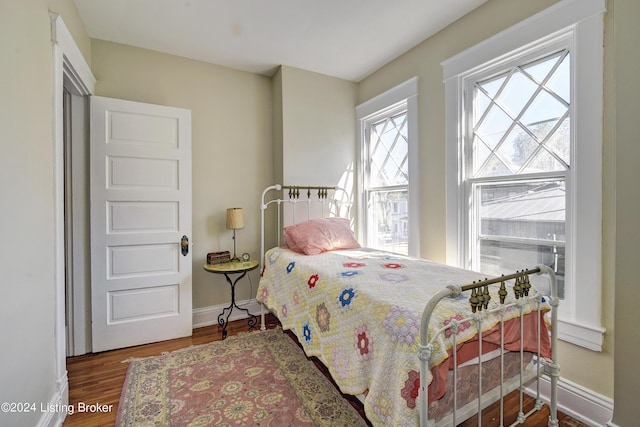 bedroom with wood finished floors and baseboards