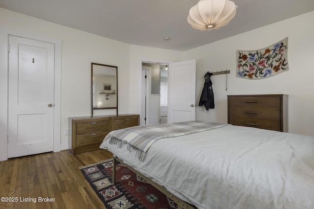 bedroom featuring wood-type flooring and a textured ceiling