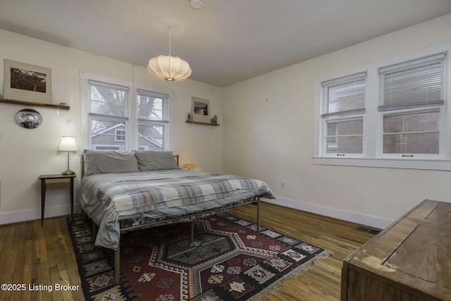 bedroom with wood finished floors and baseboards