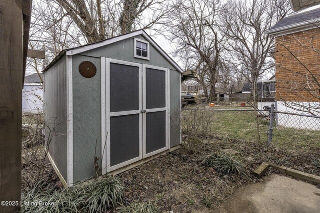 view of shed featuring fence