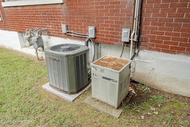 exterior details featuring central air condition unit, gas meter, and brick siding