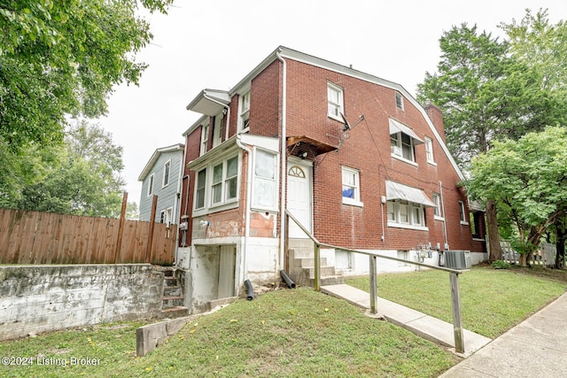 view of property with entry steps, fence, and central AC unit