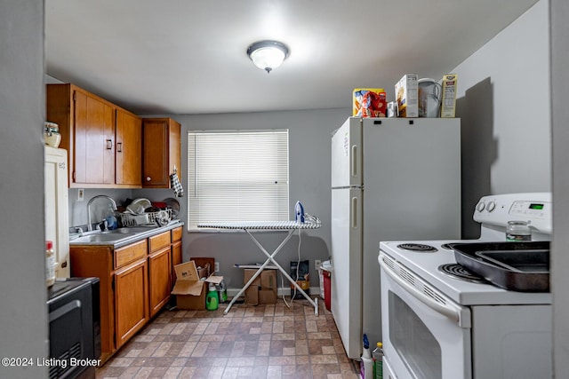 kitchen with light countertops, brown cabinetry, a sink, and white electric range oven