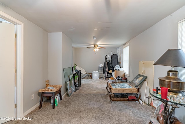 interior space with ceiling fan, carpet flooring, and baseboards