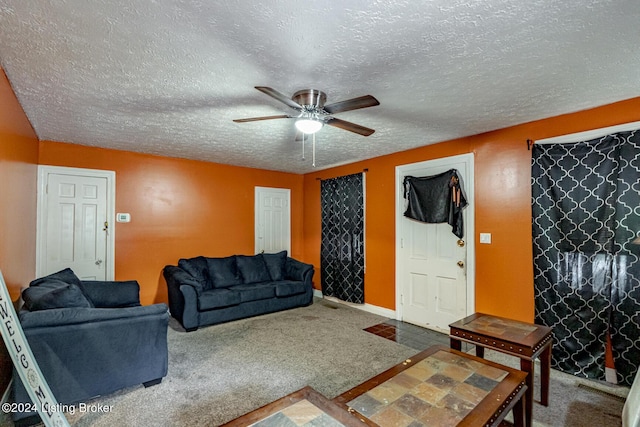 living room with carpet floors, ceiling fan, and a textured ceiling