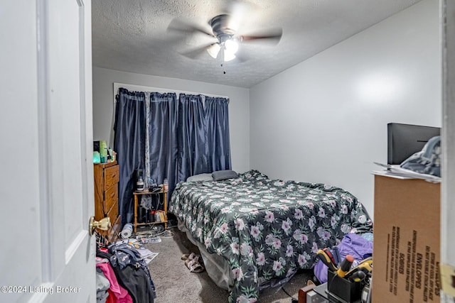 carpeted bedroom with a ceiling fan and a textured ceiling