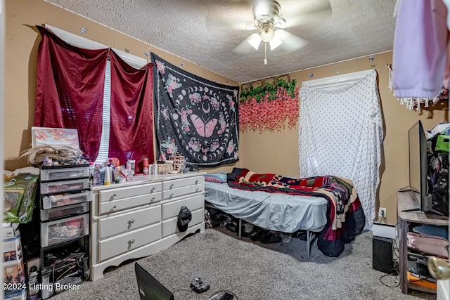 carpeted bedroom with a textured ceiling and a ceiling fan