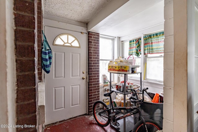 entryway featuring a textured ceiling