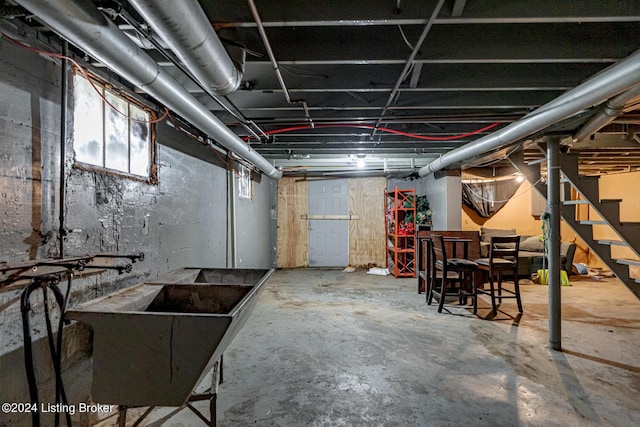 basement featuring a sink and stairway