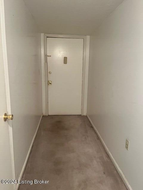 corridor featuring baseboards