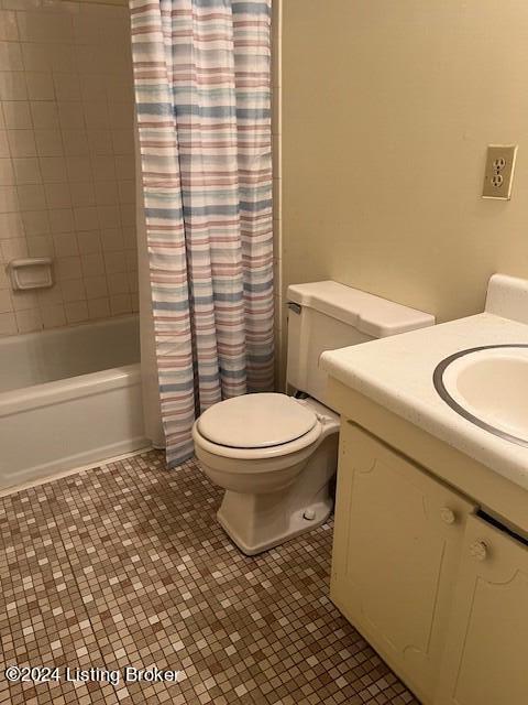 bathroom with shower / tub combo, vanity, toilet, and tile patterned floors