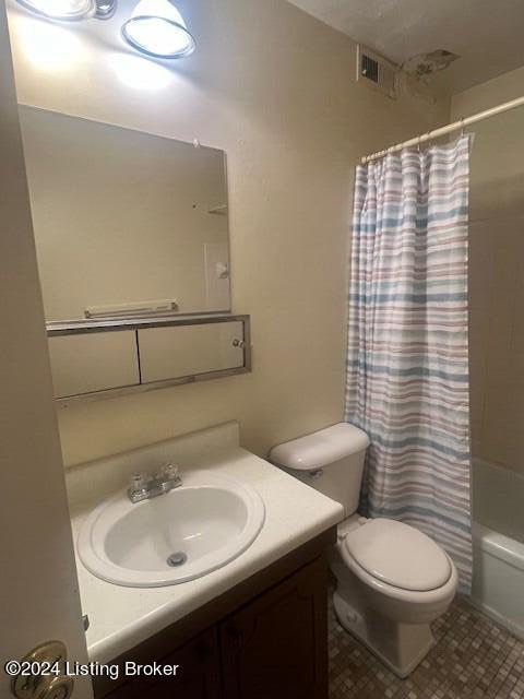 bathroom featuring toilet, shower / tub combo, visible vents, and vanity