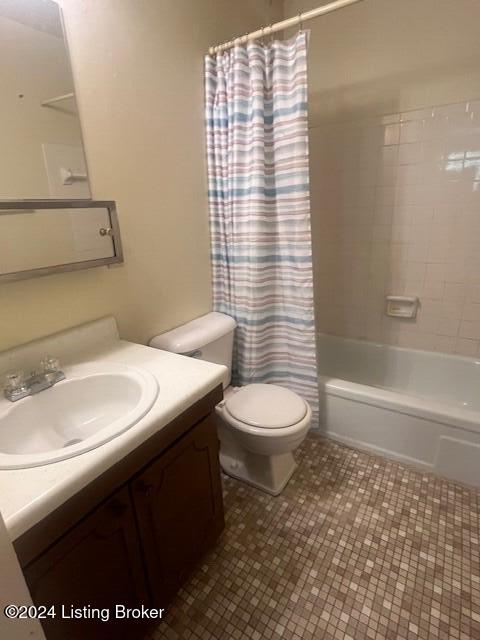 full bathroom featuring shower / bath combination with curtain, tile patterned flooring, vanity, and toilet