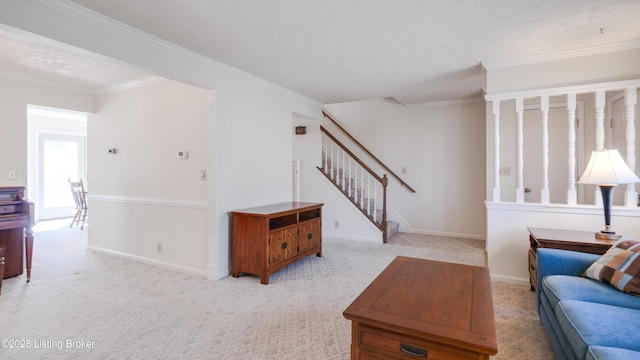 living area featuring stairway, ornamental molding, baseboards, and carpet floors