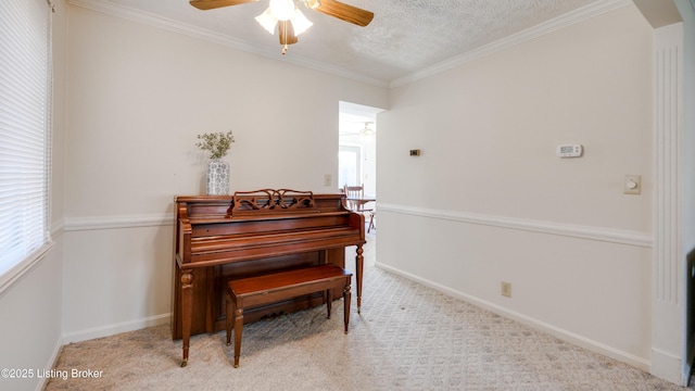 living area featuring a textured ceiling, crown molding, a ceiling fan, and carpet floors