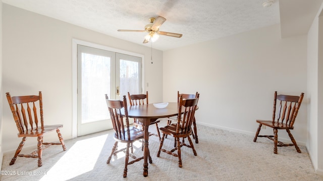 dining room with carpet, a healthy amount of sunlight, and a textured ceiling