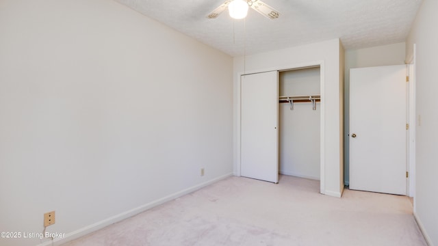 unfurnished bedroom featuring baseboards, a closet, carpet floors, and a textured ceiling